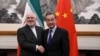 China's Foreign Minister Wang Yi shakes hands with Iran's Foreign Minister Mohammad Javad Zarif during a meeting at the Diaoyutai state guest house in Beijing, Dec. 31, 2019.