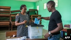 A voter casts his ballot at a polling station during Gabon's referendum in Libreville, Nov. 16, 2024. 