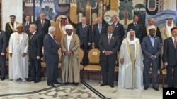Arab leaders prepare to pose for a picture ahead of the opening session of the 23rd Arab League Summit, in Baghdad, Iraq, March 29, 2012.