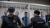 Eight Russians Convicted of Attacking Police