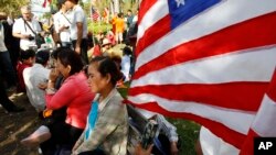 Cambodian land eviction victims wait for delivering a petition in front of U.S. Embassy to Cambodia during a rally, in Phnom Penh, Cambodia, Tuesday, Nov. 18, 2014. They demanded to release other land activists who were arrested during a protest.