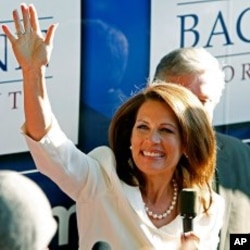 Rep. Michele Bachmann waves to supporters outside her campaign bus after being named the winner of the Iowa Republican Party's Straw Poll, Aug. 13, 2011, in Ames, Iowa