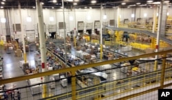 FILE - One of Amazon's distribution centers in Tracy, Calif., is seen during a tour, Nov. 30, 2014.