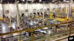 FILE - One of Amazon's distribution centers in Tracy, Calif., is seen during a tour, Nov. 30, 2014. 