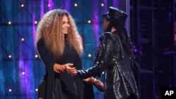 Janelle Monae, right, presents a trophy to inductee Janet Jackson at the Rock and Roll Hall of Fame induction ceremony at the Barclays Center, March 29, 2019, in New York.