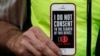 A man holds up his iPhone during a rally in support of data privacy outside an Apple store in San Francisco, Calif., Feb. 23, 2016. Protesters lashed out at a government order requiring Apple to help unlock an encrypted iPhone.