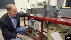 Professor Kai Vetter of the Department of Nuclear Engineering at the University of California at Berkeley kneels beside a germanium detector which is used to identify radioactive airborne particulates in a filter taken from air samples in Berkeley, Califo