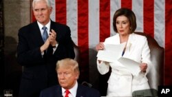 House Speaker Nancy Pelosi of Calif., tears her copy of President Donald Trump's State of the Union address after he delivered it to a joint session of Congress Feb. 4, 2020. Vice President Mike Pence is at left. (AP Photo/Patrick Semansky)