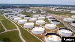 Crude oil storage tanks are seen in an aerial photograph at the Cushing oil hub in Cushing, Oklahoma, US.