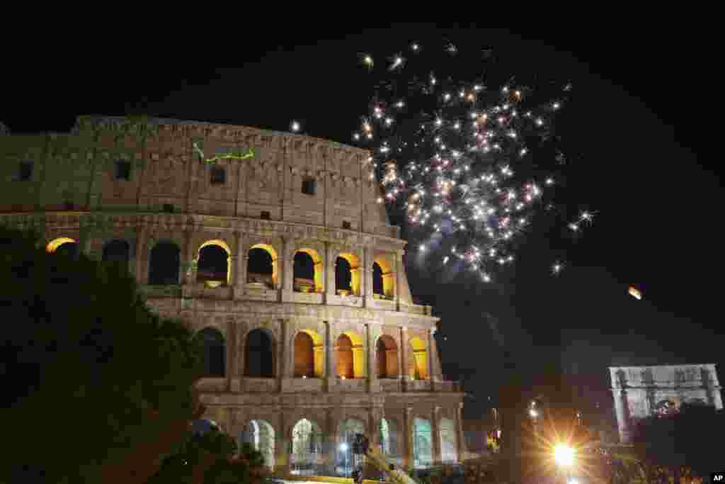 Fireworks explode in the sky over Rome's Colosseum during New Year's celebrations, in Rome, Italy, Jan. 1, 2019.