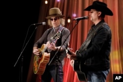 FILE - Kenny Alphin, left, and John Rich, right, of the country music duo Big & Rich, perform a song during a taping for Dolly Parton's Smoky Mountain Rise Telethon in Nashville, Tennessee, Dec. 13, 2016.