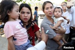 Families of jailed Reuters reporters Wa Lone and Kyaw Soe Oo talk to the media after attending a hearing at Myanmar's Supreme Court in Naypyitaw, Myanmar, March 26, 2019.