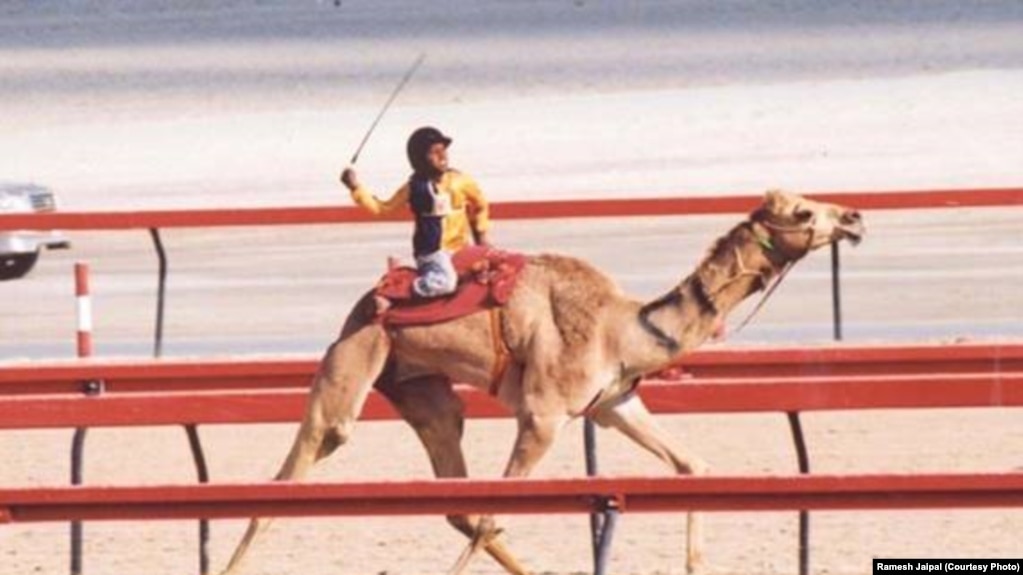 Ramesh Jaipal, who was sold into slavery as a child, is seen racing a camel in Dubai at age 6.