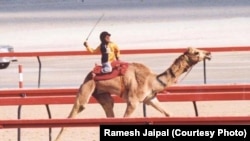 Ramesh Jaipal, who was sold into slavery as a child, is seen racing a camel in Dubai at age 6.