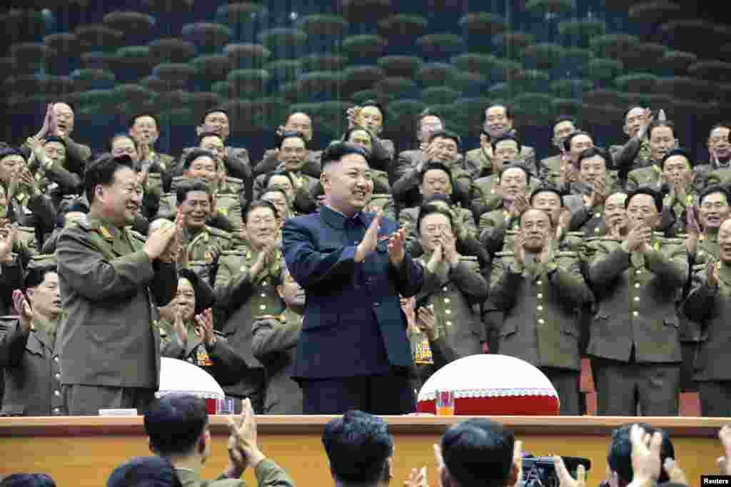 Military officials applaud with North Korean leader Kim Jong Un, during the Unhasu concert in Pyongyang, in a photo released April 16, 2013. (KCNA)