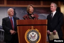 Sens. Ben Cardin (D-MD) (L), Lisa Murkowski (R-AK) (C) and Chris Van Hollen (D-MD) hold a press conference about a bipartisan solution after the failure of both competing Republican and Democratic proposals to end the partial government shutdown in back to back votes on Capitol Hill in Washington, U.S., Jan. 24, 2019.