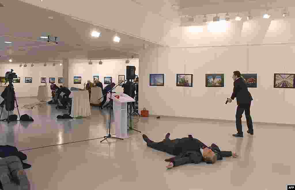 Andrey Karlov (2ndR), the Russian ambassador to Ankara, lying on the floor after being shot by a gunman (R) during an attack during a public event in Ankara, Turkey. A gunman crying "Aleppo" and "revenge" shot Karlov while he was visiting an art exhibition in Ankara, witnesses and media reports said. The Turkish state-run Anadolu news agency said the gunman had been "neutralised" in a police operation, without giving further details.