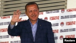 Turkey's Prime Minister Tayyip Erdogan waves to supporters as he celebrates his election victory in front of the party headquarters in Ankara August 10, 2014. Erdogan secured his place in history as Turkey's first directly elected president on Sunday, swe