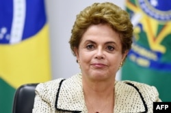 FILE - Brazilian President Dilma Rousseff gestures during a meeting with representatives of the National Council of Christian Churches of Brazil (CONIC) at the Planalto Palace in Brasilia, Feb. 10, 2016.