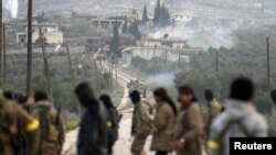 Turkish-backed Free Syrian Army fighters advance in Rajo, Syria, March 3, 2018. 