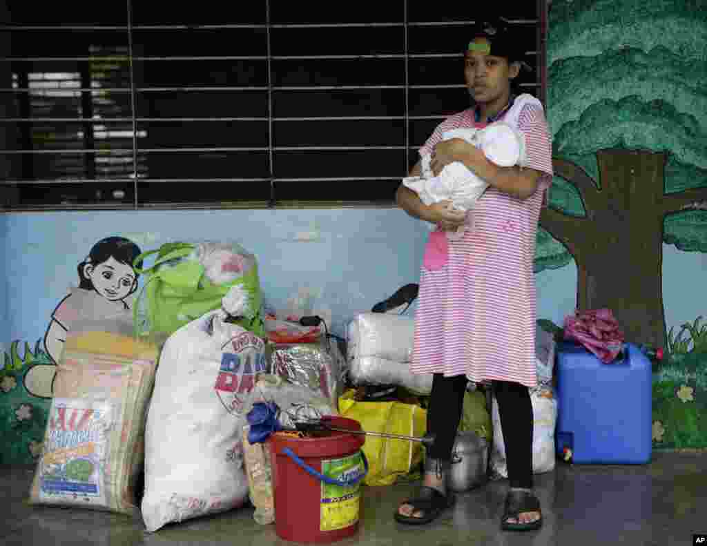 Residents make use of the corridors of a public school as their temporary shelter after fleeing their flooded homes in Marikina city, east of Manila, August 20, 2013.