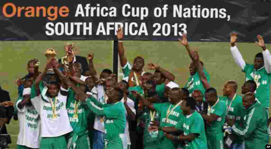 Nigeria's soccer team hold the trophy as they celebrate after winning the African Cup of Nations final soccer match against Burkina Faso at Soccer City Stadium in Johannesburg, South Africa, Sunday, Feb. 10, 2013. (AP Photo/Themba Hadebe)