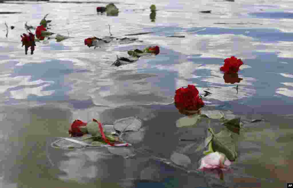 Flowers float in a lake at the former Nazi concentration camp Ravensbrueck in Fuerstenberg, northeastern Germany, to commemorate the 70th anniversary of the liberation of the camp by the Red Army on April 30, 1945.