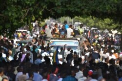 Sudanese protesters sit outside the presidential palace in Khartoum, demanding a return to military rule, Oct. 21, 2021, as supporters of Sudan's transitional government took to the city's streets in opposition to pro-military demonstrators.