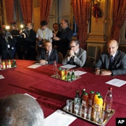 French Foreign Minister Alain Juppe (R) and members of the Turkish National Assembly are seen ahead of their meeting in Paris, December 20, 2011