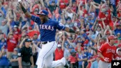 Texas Rangers' Hanser Alberto runs onto the field after the final out of the baseball game against the Los Angeles Angels in Arlington, Texas, Sunday, Oct. 4, 2015. 