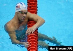 United States' Michael Phelps holds on a lane marker during a training session prior to the 2016 Summer Olympics in Rio de Janeiro, Brazil, Tuesday, Aug. 2, 2016.