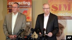 Will Elphick, left, director of Liberia for SIM, USA listens as SIM President Bruce Johnson speaks at a news conference in Charlotte, N.C., Wednesday, Sept., 3, 2014.