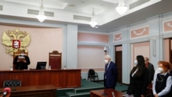 A judge of the Russian Supreme Court delivers the verdict during a hearing to consider the closure of the human rights group International Memorial in Moscow, Dec. 28, 2021.