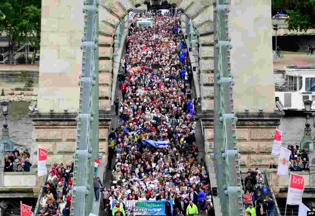 Jewish participants and their sympathizers hold a banner (down) with a text, &#39;March for Life Hungary&#39; during a demonstration on the oldest Hungarian bridge the &#39;Lanchid&#39; (Chain Bridge) in Budapest. The &quot;March for Life&quot; commemorates the anniversary of the Holocaust that caused the death of thousands of victims who were deported to the concentration camps by the Nazis.