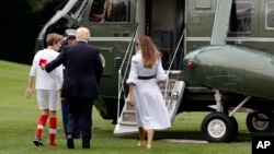 President Donald Trump, first lady Melania Trump, and their son, Barron Trump, board Marine One on the South Lawn of the White House in Washington, en route to Camp David in Maryland, June 17, 2017.