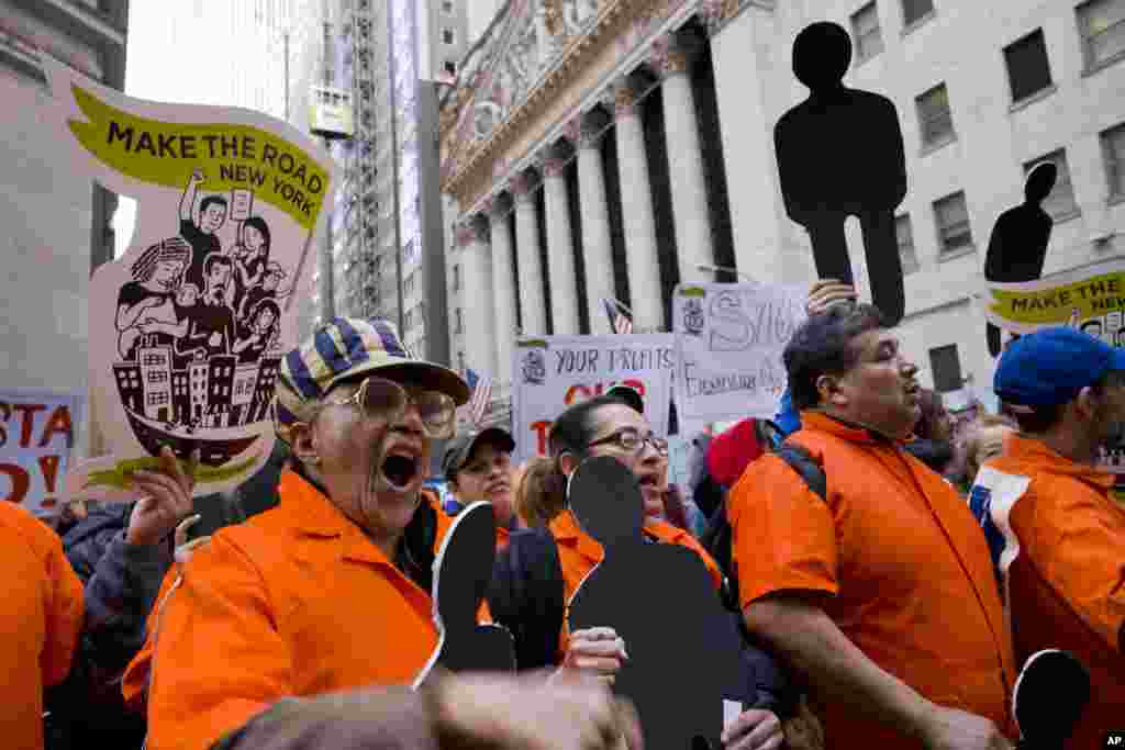 Protesters march on Wall Street in front of the New York Stock Exchange, May 1, 2018.