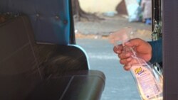 A tuk tuk driver sanitizes the seats after a ride to prevent the spread of COVID-19 in Phnom Penh, Cambodia, on March 28, 2020. (Khan Sokummono/VOA Khmer)