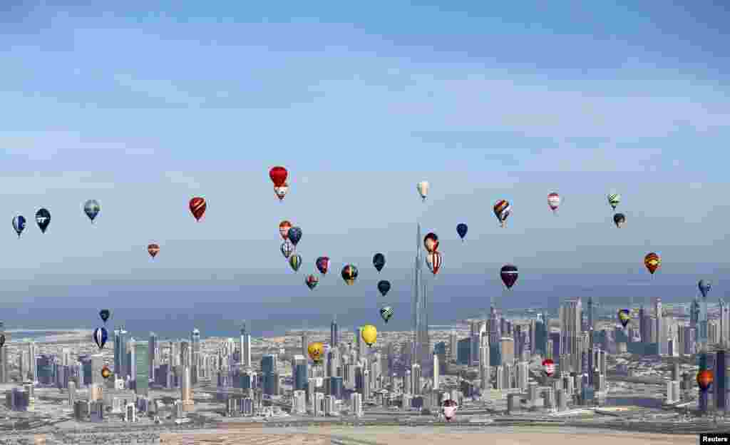 Hot air balloons fly over Dubai during the World Air Games 2015, held under the rules of the Fédération Aéronautique Internationale(FAI) as part of the "Dubai International Balloon Fiesta" event, United Arab Emirates.