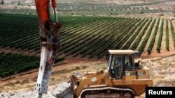 A man operates a bulldozer on a field as work begins on the construction of Amichai, a new settlement which will house some 300 Jewish settlers evicted in February from the illegal West Bank settlement of Amona, in the West Bank, June 20, 2017. 