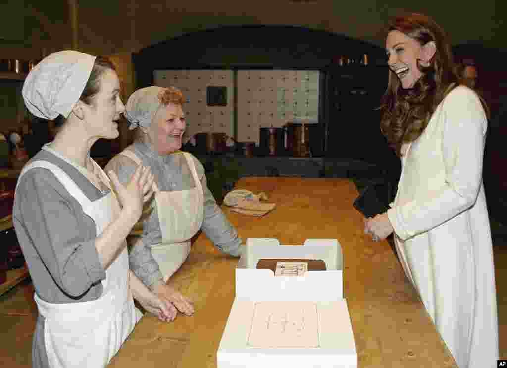 Britain&#39;s Duchess of Cambridge, Kate Middleton, chats to cast members Sopie McShera, left, and Lesley Nicol during an official visit to the set of the TV series Downton Abbey at Ealing Studios in London.