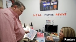 Barry Bennett checks election posters at the Republican presidential candidate Ben Carson's headquarters in Alexandria, Virginia, Oct. 20, 2015.