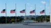 American flags around the Washington Monument are lowered to half-staff in honor of Colin Powell, former Joint Chiefs chairman and secretary of state, Oct. 18, 2021. Powell died from COVID-19 complications.