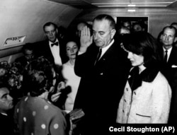 FILE - Lyndon B. Johnson is sworn in as President of the United States of America in the cabin of the presidential plane as Mrs. Jacqueline Kennedy stands at his side Nov. 22,1963. AP Photo/White House, Cecil Stoughton)