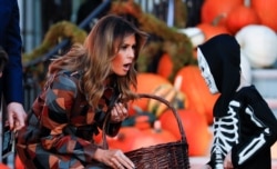 First lady Melania Trump hand out Halloween candy to visiting schoolchildren