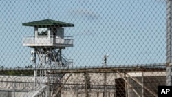 FILE - A guard tower stands above a maximum security prison in South Carolina.