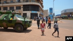 An armored vehicle of of the Congolese army, part of the Central African Multinational Force is parked in front of a bank in central Bangui on April 3, 2013. 
