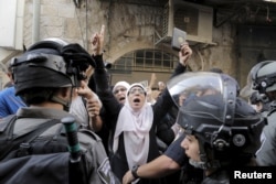 Israeli policemen prevent Palestinian women from entering the compound that houses Al-Aqsa mosque, known by Muslims as the Noble Sanctuary and by Jews as the Temple Mount, in Jerusalem's Old City, Sept. 13, 2015.