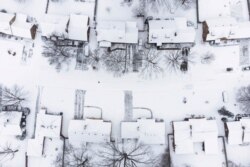 Snow covers a neighborhood during a winter storm in Dayton, Ohio, Jan. 17, 2022.