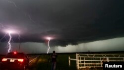Cloud to ground lightning strikes near storm chasers during a tornadic thunderstorm in Cushing, Oklahoma, May 31, 2013