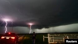 Cloud to ground lightning strikes near storm chasers during a tornadic thunderstorm in Cushing, Oklahoma, May 31, 2013